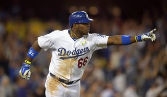 Los Angeles Dodgers right fielder Yasiel Puig gestures after hitting a three-run home during the fourth  inning of a baseball game against the Miami Marlins, Monday, May 12, 2014, in Los Angeles. (AP Photo)
