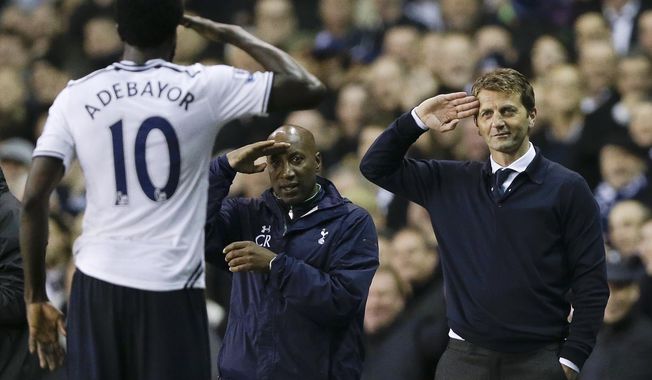 FILE - This is a  Monday, April 7, 2014  file photo of Tottenham&#x27;s manager Tim Sherwood, right, as he salutes striker  Emmanuel Adebayor, left, after he scored a goal during the English Premier League soccer match between Tottenham Hotspur and Sunderland at White Hart Lane stadium in London. Tottenham  fired manager Tim Sherwood Tuesday May 13, 2014 less than five months into his first coaching job. The Premier League club says it has exercised the end-of-season break clause in Sherwood&#x27;s 18-month contract. The inexperienced Englishman was promoted within the north London club in December after Andre Villas-Boas was fired. (AP Photo/Kirsty Wigglesworth. File)
