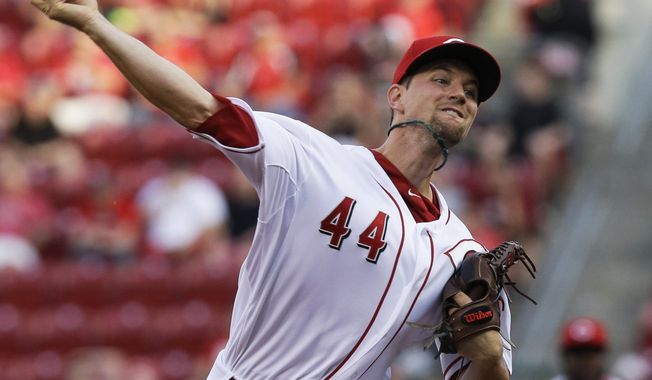 Cincinnati Reds starting pitcher Mike Leake throws against the San Diego Padres in the first inning of a baseball game, Tuesday, May 13, 2014, in Cincinnati. (AP Photo)