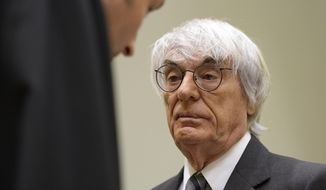 Formula One boss Bernie Ecclestone, right, waits prior to the fourth day of his trial at the courthouse in Munich, southern Germany, Tuesday, May 13, 2014. Ecclestone is charged with bribery and incitement to breach of trust &amp;quot;in an especially grave case&amp;quot; over a US dollar 44 million payment to a German banker, that prosecutors allege was meant to facilitate the sale of the Formula One Group to a buyer of Ecclestone&#39;s liking. (AP Photo/Christof Stache, Pool)