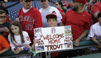 Justin Shephard, nine years old, from Deptford, N.J., holds up a sign for Los Angeles Angels&#39; Mike Trout before the start of a baseball game with the Philadelphia Phillies, Tuesday, May 13, 2014, in Philadelphia. (AP Photo/Laurence Kesterson)