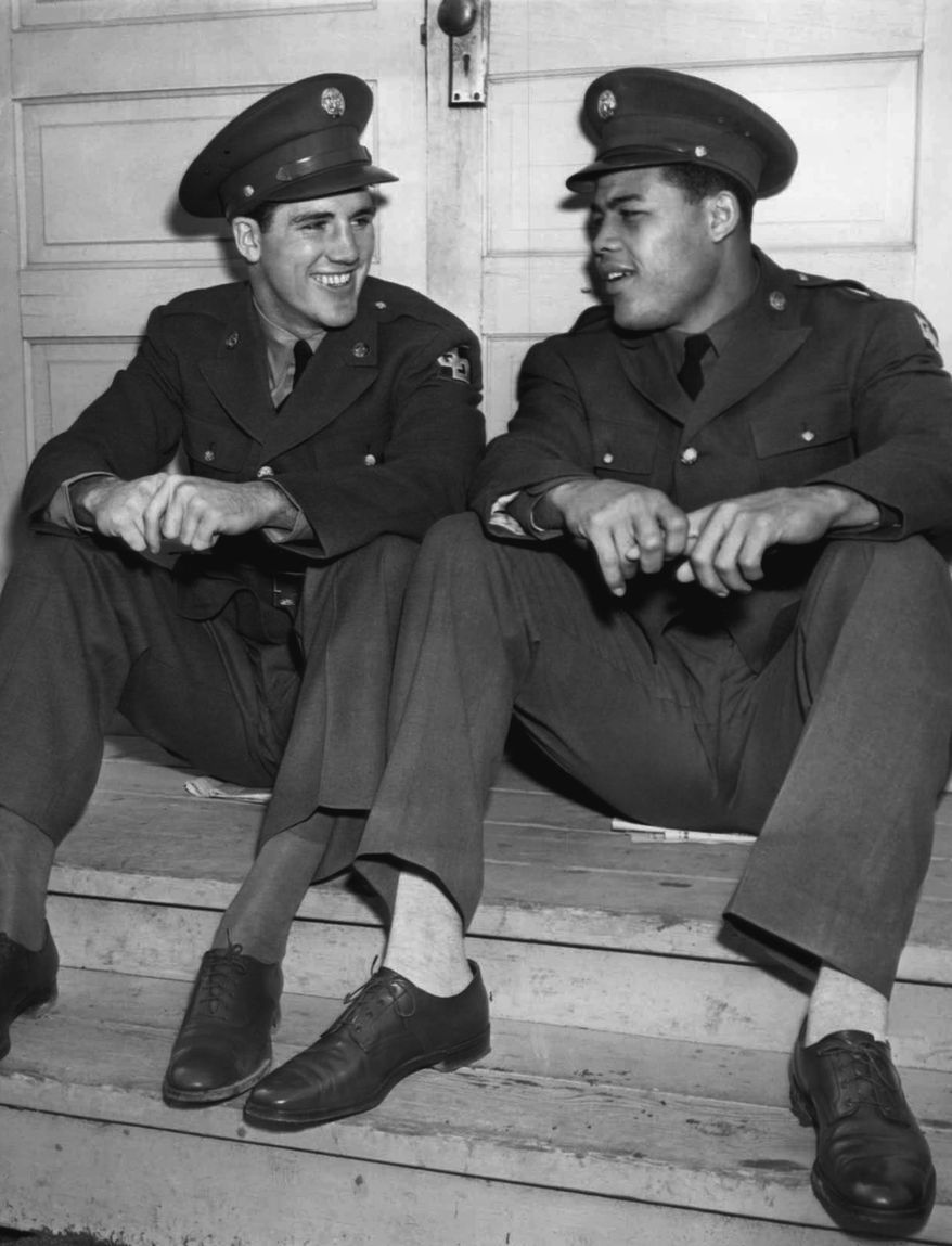 Private Billy Conn talked over old times as he visited Private Joe Louis at Fort Dix, New Jersey on March 22, 1942 as the world heavyweight champ spent some time training for his coming fight on March 27 with Abe Simon in New York for the Army Emergency Relief Fund. Conn knows something about how Simon may feel because he once fought Joe himself. (AP Photo)