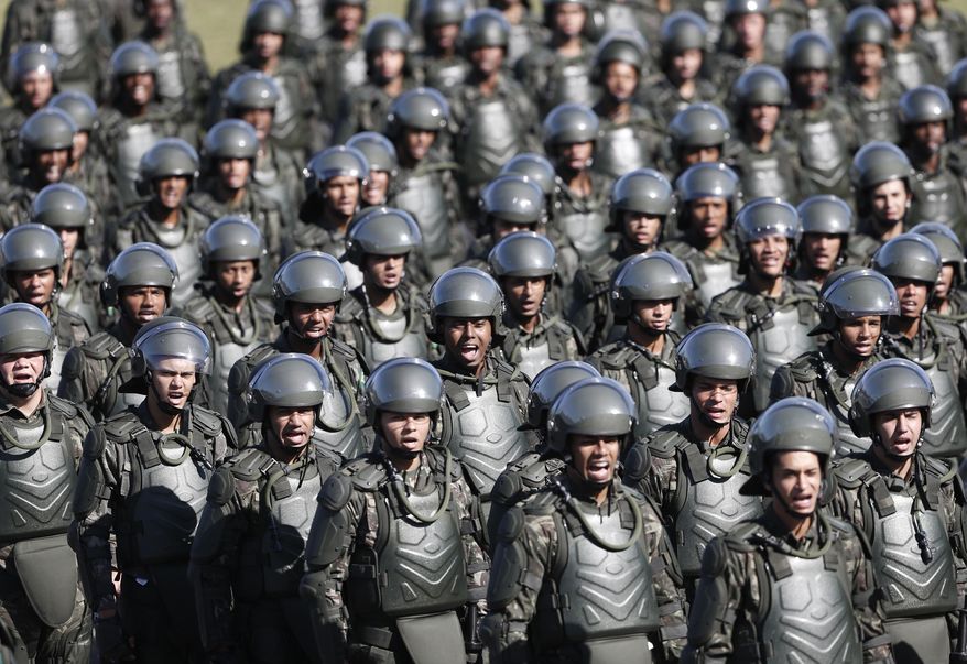 Soldiers take part in a ceremony presenting the troops who will provide security during the World Cup at Brigadier Sampaio Camp in Rio de Janeiro, Brazil, Monday, May 12, 2014. Rio de Janeiro is one of the host cities for the 2014 World Cup soccer tournament that starts on June 12. (AP Photo/Silvia Izquierdo)