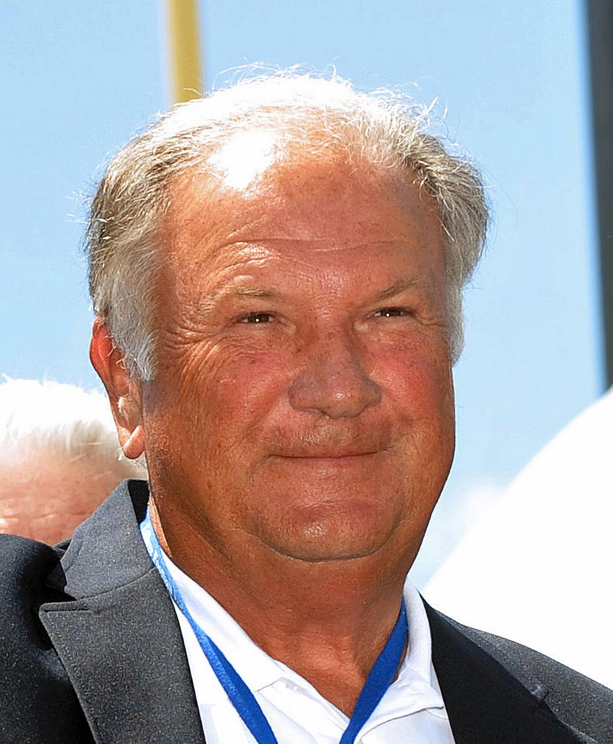 FILE - This July 18, 2009, file photo, shows former Georgia football coach Jim Donnan after receiving his blazer during the College Hall of Fame pep rally in South Bend, Ind. A prosecutor said former University of Georgia football coach Jim Donnan lured his friends into a fraudulent investment scheme because he was blinded by the enormous amount of money he could make. Prosecutor Pete Peterman made that assertion Wednesday, May 14, 2014, in his closing argument in Donnan's trial on charges including wire fraud, mail fraud and money laundering. (AP Photo/Joe Raymond, File)