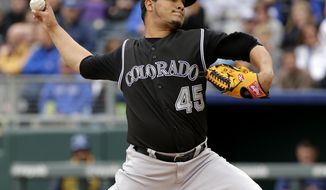 Colorado Rockies starting pitcher Jhoulys Chacin throws during the first inning of a baseball game against the Kansas City Royals Wednesday, May 14, 2014 in Kansas City, Mo. (AP Photo/Charlie Riedel)