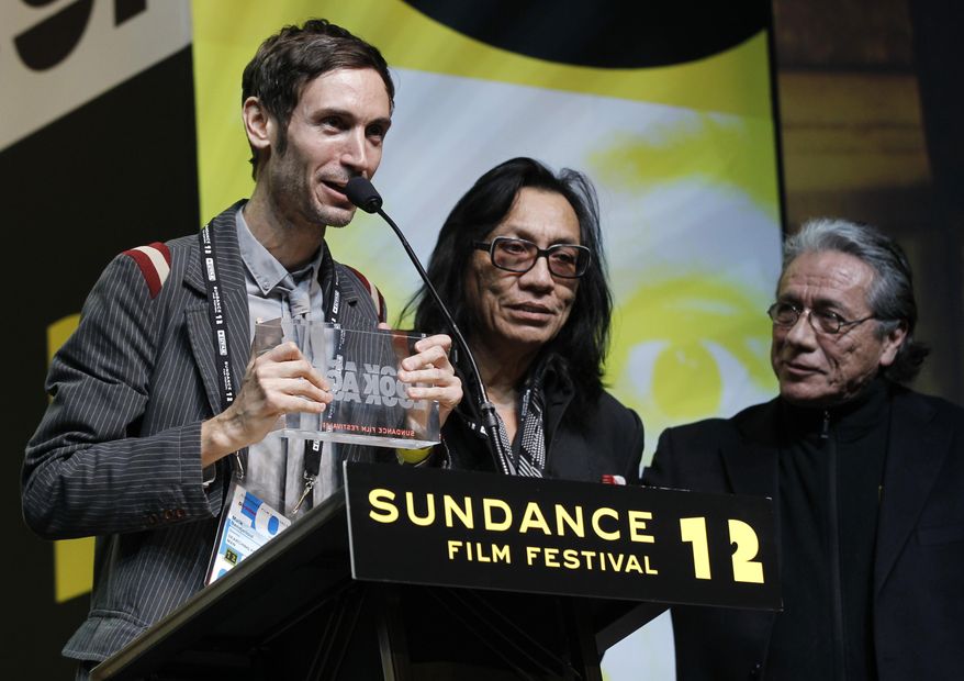 FILE - This Jan. 28, 2012 file photo shows Swedish director Malik Bendjelloul, left, and documentary film subject Rodriguez, center, accepting the World Cinema Audience Award: Documentary for the film "Searching for Sugar Man" as presenter Edward James Olmos, right, looks on during the 2012 Sundance Film Festival Awards Ceremony in Park City, Utah. Police in Sweden say Malik Bendjelloul has died. He was 36. Police spokeswoman Pia Glenvik said Bendjelloul died in Stockholm late Tuesday, May 13, 2014, but wouldn't specify the cause of death. (AP Photo/Danny Moloshok, FIle)
