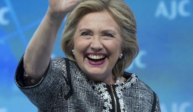 Former Secretary of State Hillary Rodham Clinton waves to the audience at the conclusion of her address to the American Jewish Committee (AJC) Global Forum closing plenary in Washington, Wednesday, May 14, 2014. (AP Photo/Cliff Owen)