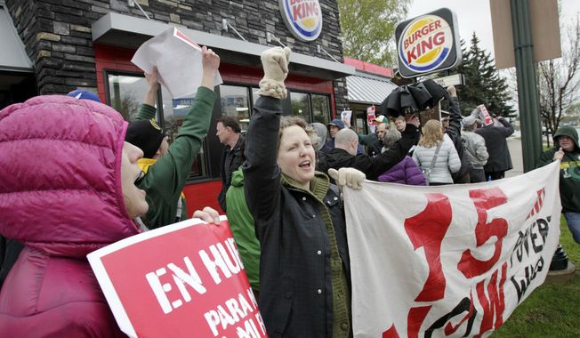 Protesters picket outside of a Burger King restaurant on East Washington Avenue in Madison, Wis., Thursday, May 15, 2014. Protesters in Madison joined others across the world gathering to turn up the pressure on fast-food chains to raise worker pay. (AP Photo/Wisconsin State Journal, M.P. King)