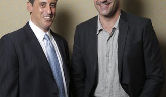 This Sunday, April 13, 2014 photo shows J. B. Bernstein, left, posing with actor Jon Hamm who plays him in the film &amp;quot;Million Dollar Arm,&amp;quot; in Los Angeles. To portray Bernstein, the sports agent behind the signing of the first two Indian Major Leaguers,&amp;quot; Hamm had to act like a noble guy in Disney’s “Million Dollar Arm” instead of the cutthroat ad exec he embodies on TV’s “Mad Men.” The movie releases in U.S. theaters on Friday, May 16, 2014. (Photo by Todd Williamson/Invision/AP)