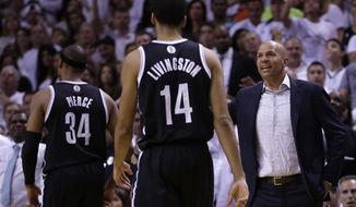Brooklyn Nets head coach Jason Kidd, right, talks to his players as they head in for a timeout during the second half of Game 5 of a second-round NBA playoff basketball game against the Miami Heat in Miami, Wednesday, May 14, 2014. The Heat won 96-94. (AP Photo)