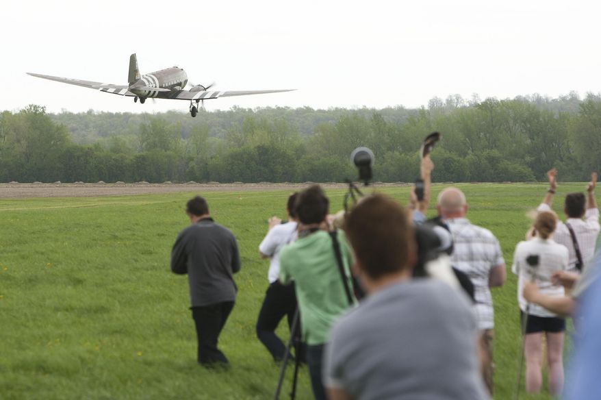 The C-47 'Whiskey 7' starts its takeoff for the "Return to Normandy" project being carried out by the Geneseo National Warplane Museum in Geneseo, N.Y., on Thursday May 15 2014.  The Douglas C-47, a World War II transport plane that dropped American paratroopers on Normandy departed from Geneseo, in New York Thursday for a D-Day 70th anniversary commemoration in France. (AP Photo/Democrat & Chronicle, Carlos Ortiz)  MAGS OUT; NO SALES