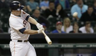 Houston Astros&#x27; Matt Dominguez hits an RBI single against the Texas Rangers in the ninth inning of a baseball game Wednesday, May 14, 2014, in Houston. The Astros won 5-4. (AP Photo)