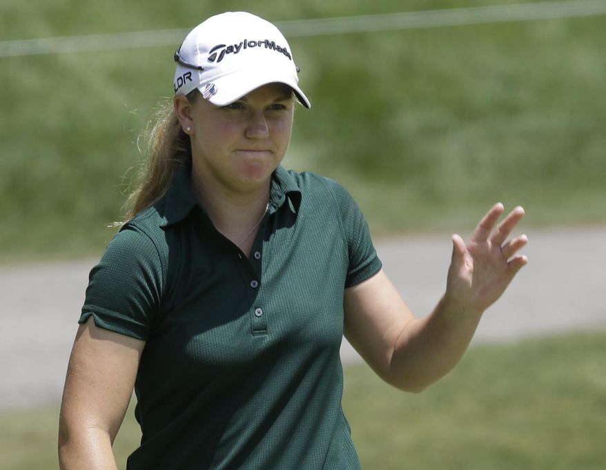 Austin Ernst waves to the gallery after a par saving putt on the eighth hole during the first round of the Kingsmill Championship golf tournament at the Kingsmill resort in Williamsburg, Va., Thursday, May 15, 2014. Ernst finished the round at 6-under-65. (AP Photo/Steve Helber)