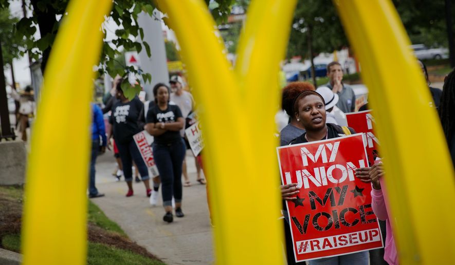 Burger King employee Brittany Buckhannon, 24, right, demonstrates during a protest for higher wages and worker&#x27;s unions outside a McDonald&#x27;s restaurant, Thursday, May 15, 2014, in Atlanta. Calling for higher pay and the right to form a union without retaliation, fast-food chain workers protested Thursday as part of a wave of strikes and protests in 150 cities across the U.S. and 33 additional countries on six continents. (AP Photo/David Goldman)
