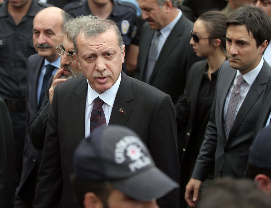 In this Wednesday, May 14, 2014, photo, Yusuf Yerkel, right, advisor to Turkish Prime Minister Recep Tayyip Erdogan, stands behind Erdogan during his visit in Soma, Turkey. Yerkel  was identified by Turkish media as the advisor who kicked a protester who was held by special forces police members during Erdogan&#x27;s visit to  Soma, Turkey. Erdogan was visiting the western Turkish mining town of Soma after Turkey&#x27;s worst mining accident . (AP Photo/Emrah Gurel)