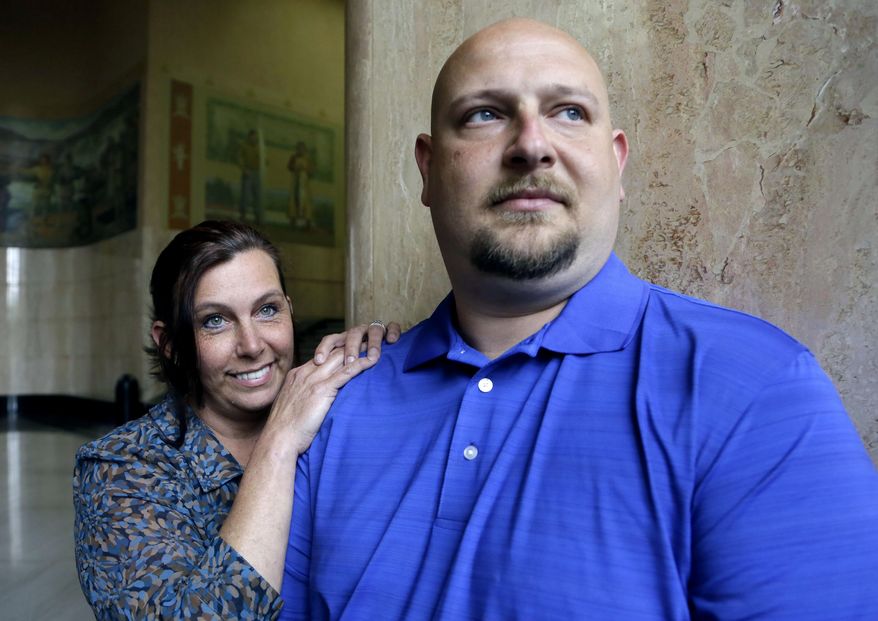 In this May 8, 2014 photo, former Spartanburg, S.C., sheriff's deputy Brandon Bentley, poses for a photo with his wife, retired Salem police department officer Kelly Clark, in Salem, Ore. Bentley's appeal to the South Carolina Supreme Court on a post-traumatic stress disorder claim was denied, stating the law did not provide mental health benefits for officers because they are trained in the use of deadly force and know that they may have to use it. (AP Photo/Don Ryan)