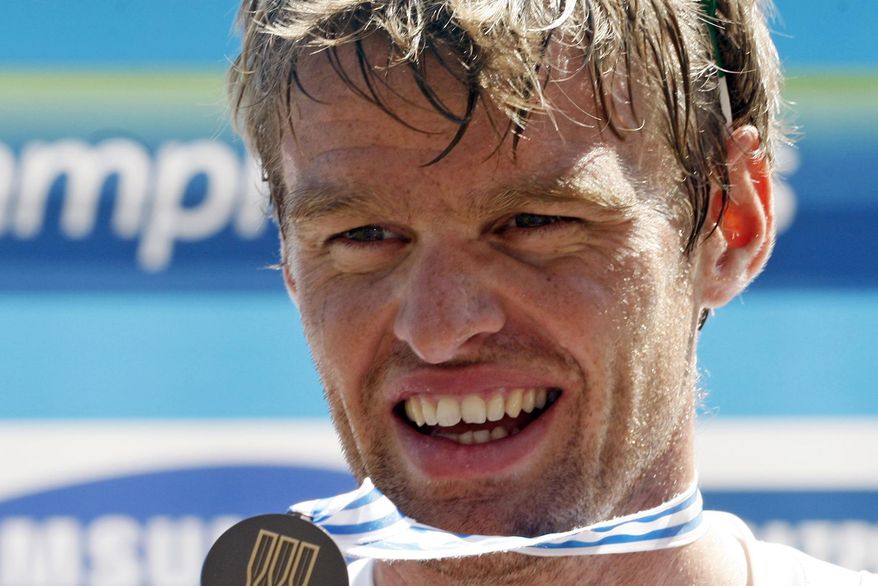 FILE -  In this Saturday, Sept. 3, 2011 file photo, British rower Alan Campbell displays his bronze medal on the podium after the Men's Single Sculls Final event at the World Rowing Championships in Bled, Slovenia. Campbell, whose abscessed lower-left wisdom tooth threatened to keep him from the 2008 Beijing Olympics, is certain that taking better care of his teeth has helped him row faster.  (AP Photo/Filip Horvat, File)