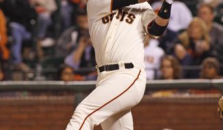 San Francisco Giants&#39; Buster Posey hits a two RBI double against the Miami Marlins during the fifth inning of a baseball game, Thursday, May 15, 2014, in San Francisco. (AP Photo/George Nikitin)