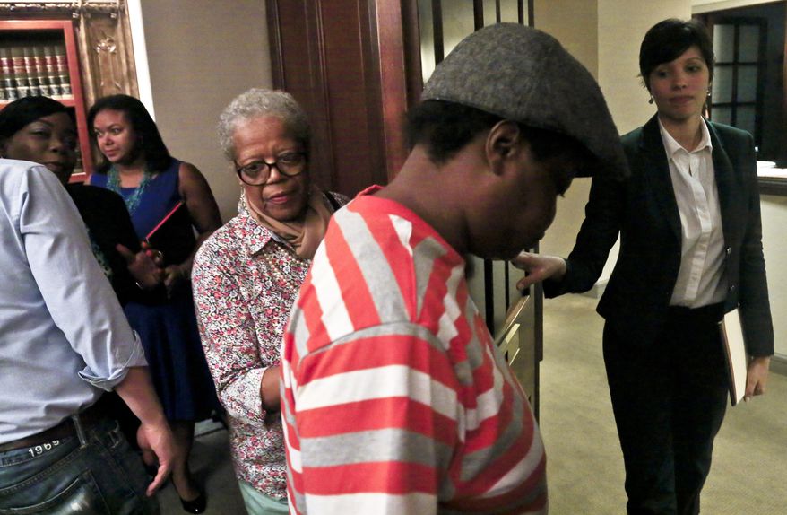 Alma Murdough, center, leaves with her granddaughter Lakisha Murdough, second from right, after a press conference detailing a $25 million wrongful death lawsuit against the city on behalf of her son Jerome Murdough, on Friday May 16, 2014 in New York. Jerome Murdough, a former Marine, was found dead in a 100 degree cell on Rikers Island. (AP Photo/Bebeto Matthews)