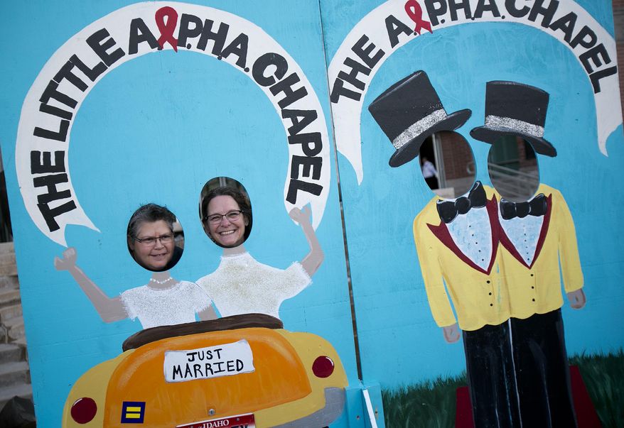 Wendi Trottier-Whitsitt, left, and partner Kari Trottier-Whitsitt, who have been together for 17 years, pose in a "Just Married" cutout in front of the Ada County Courthouse in Boise, Idaho on Friday, May 16, 2014. Idaho's gay marriage ban was overturned Tuesday when U.S. District Judge Candy Dale said the law unconstitutionally denied gay and lesbian residents their fundamental right to marry. On May 15, 2014, a three-judge panel of the 9th U.S. Circuit Court of Appeals issued a temporary stay while it considers whether a longer stay is needed. (AP Photo/The Idaho Statesman, Kyle Green) LOCAL TV OUT