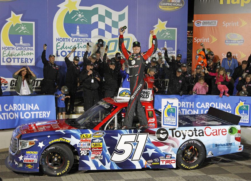 Kyle Busch celebrates in Victory Lane after winning the NASCAR Trucks series auto race at Charlotte Motor Speedway in Concord, N.C., Friday, May 16, 2014. (AP Photo/Terry Renna)