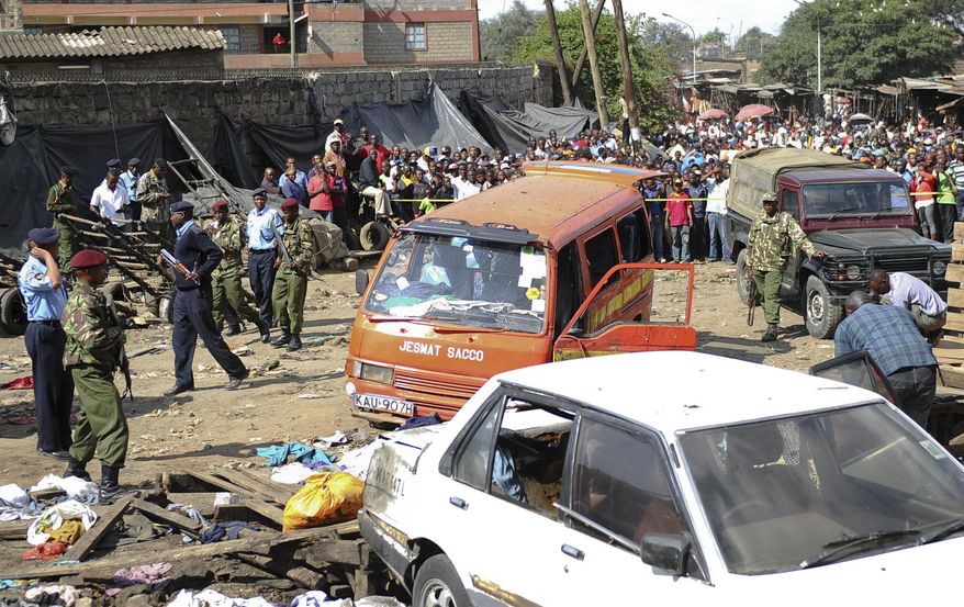 EDS NOTE: RECROP OF NAI113. Security forces secure the scene at the site where two blasts detonated, one in a mini-van used for public transportation, in a market area of Nairobi, Kenya Friday, May 16, 2014. Two blasts hit Kenya's capital on Friday, killing a number of people and injuring many more, in what appeared to be the latest in a string of increasingly frequent terror attacks. (AP Photo)
