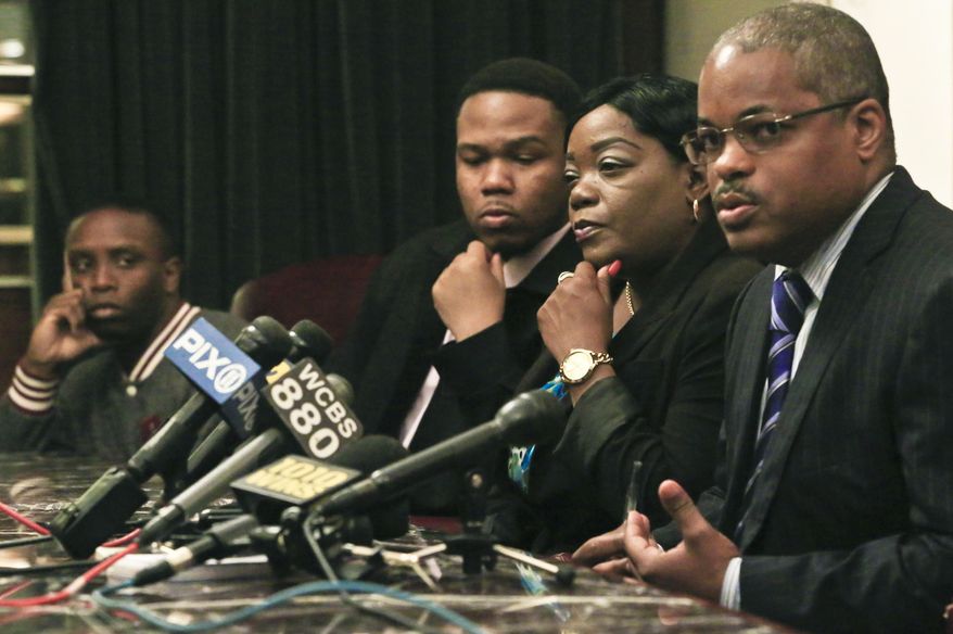 Andre Santiago, far left, Basilio Santiago, second from left, and Cheryl Warner, second from right, the nephews and sister respectively of former Marine Jerome Murdough, listen as attorney Derek Sellsb speaks during a press conference on Friday May 16, 2014 in New York. Sells plans to file a wrongful death lawsuit against the city on behalf Murdough's family for his death, after he was found dead in a 100 degree cell on Rikers Island. (AP Photo/Bebeto Matthews)