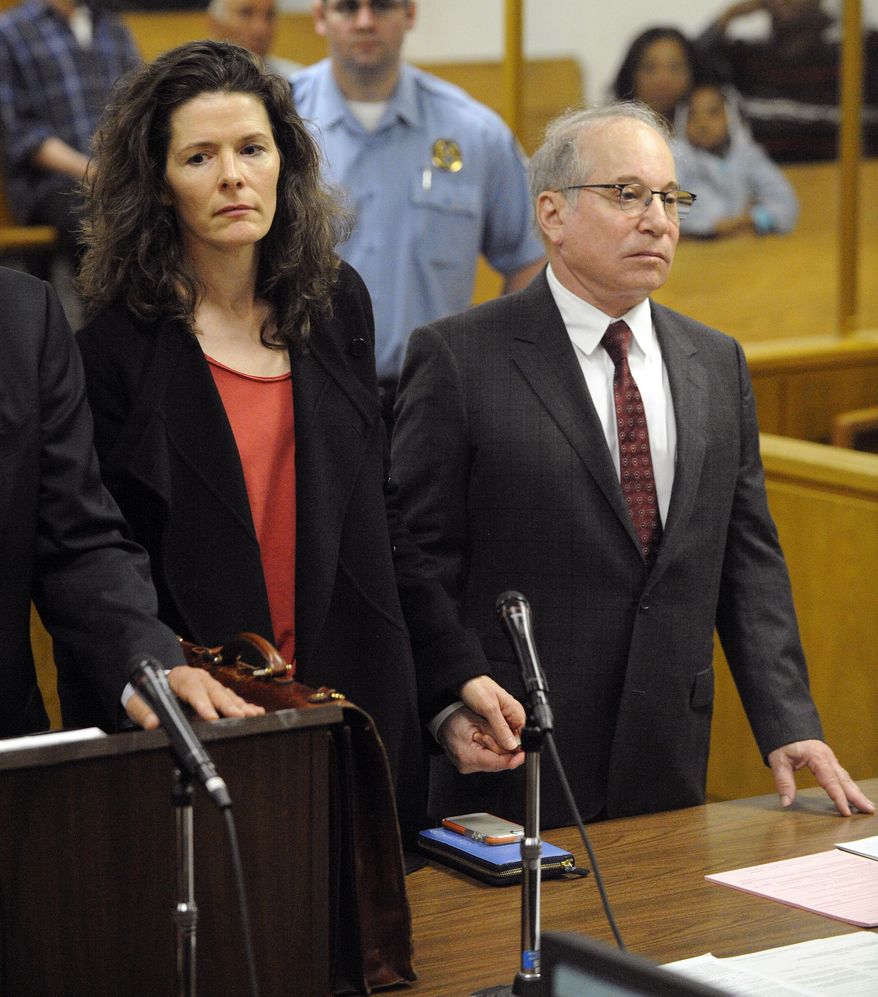 Paul Simon, right, and his wife Edie Brickell hold hands during a brief appearance in Superior Court for their disorderly conduct case Friday May, 16, 2014 in Norwalk, Conn. A police report says the Brickell, 48, and Simon, 72, became physical with each other during an April 26 argument inside a cottage on their New Canaan property. The case was continued until June 17. (AP Photo/New York Post, Douglas Healey, Pool)