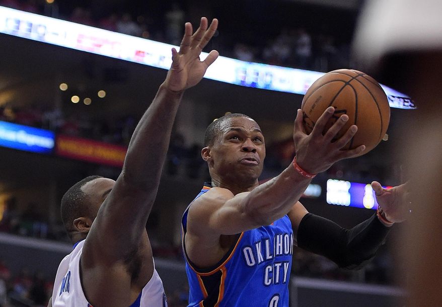 Oklahoma City Thunder guard Russell Westbrook, right, puts up a shot as Los Angeles Clippers forward Glen Davis defends in the second half of Game 6 of the Western Conference semifinal NBA basketball playoff series, Thursday, May 15, 2014, in Los Angeles. The Thunder won 104-98, taking the series 4-2. (AP Photo/Mark J. Terrill)