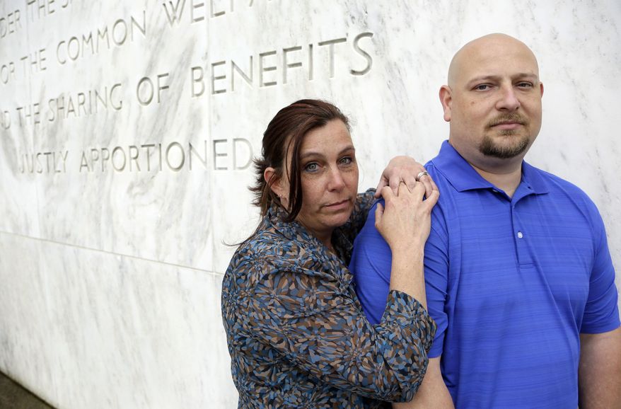 In this May 8, 2014 photo, former Spartanburg, S.C., sheriff's deputy Brandon Bentley, poses for a photo with his wife, retired Salem police department officer Kelly Clark, in front of the Capitol building in Salem, Ore. Bentley's appeal to the South Carolina Supreme Court on a post-traumatic stress disorder claim was denied, stating the law did not provide mental health benefits for officers because they are trained in the use of deadly force and know that they may have to use it. (AP Photo/Don Ryan)