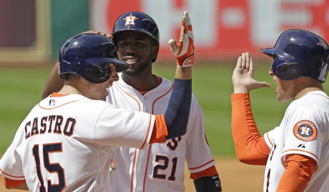 Houston Astros&#x27; Jason Castro (15), Dexter Fowler (21) and George Springer celebrate Castro&#x27;s three-run homer against the Chicago White Sox in the first inning of a baseball game, Saturday, May 17, 2014, in Houston. (AP Photo/Pat Sullivan)