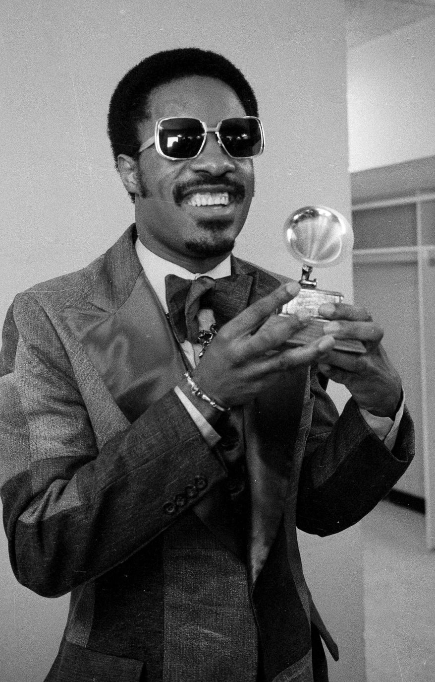 FILE -- In this March 1, 1975 file photo, singer Stevie Wonder holds the Grammy Award presented to him for "Best Male Pop Vocalist," during the annual Grammy Awards ceremony held in New York City. Determined to retire after five decades in Hollywood, Elliot Mintz, 69, is releasing what he calls a “cyberography”: A free website, ElliotMintz.com launching May 18, 2014, filled with more than 150 hours of his radio and TV interviews comprising hundreds of celebrities and subjects. Wonder, after recording 1976’s “Songs In the Key of Life,” talked to Mintz about blindness. (AP Photo, file)