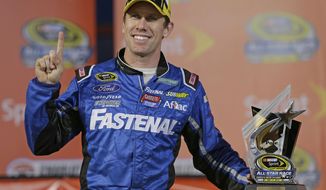 Carl Edwards poses with the trophy after winning the pole position for the NASCAR Sprint All-Star auto race at Charlotte Motor Speedway in Concord, N.C., Saturday, May 17, 2014. (AP Photo/Chuck Burton)