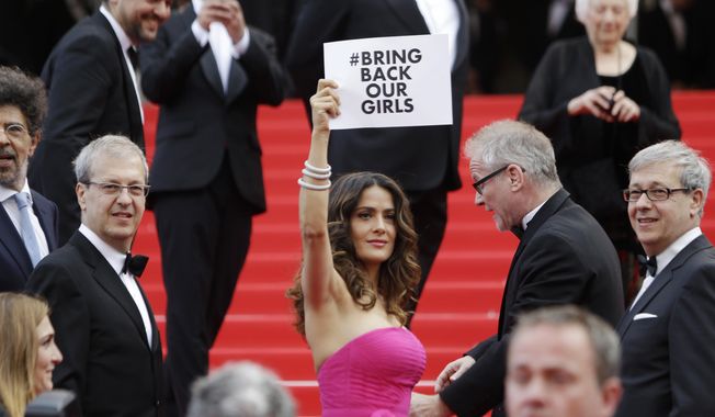 Actress Salma Hayek holds up a sign reading &amp;quot;bring back our girls&amp;quot;, part of a campaign calling for the release of nearly 300 abducted Nigerian schoolgirls being held by Nigerian Islamic extremist group Boko Haram, as she arrives for the screening of Saint-Laurent at the 67th international film festival, Cannes, southern France, Saturday, May 17, 2014. (AP Photo/Thibault Camus)