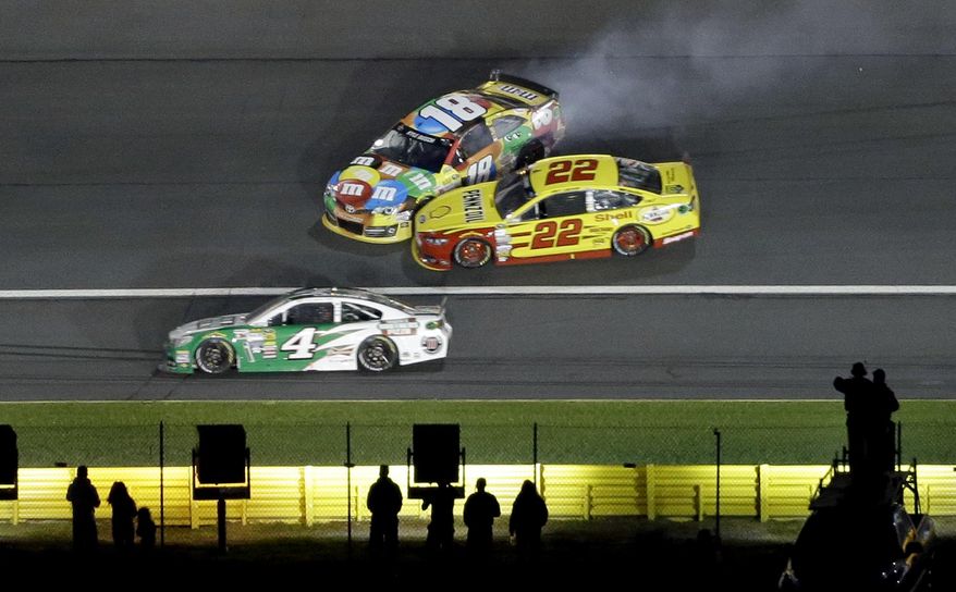 Kyle Busch (18) and Joey Logano (22) collide in Turn 3 as Kevin Harvick (4) drives low during the NASCAR Sprint All-Star auto race at Charlotte Motor Speedway in Concord, N.C., Saturday, May 17, 2014. (AP Photo/Gerry Broome)