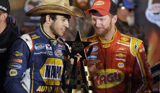 FILE - In this April 4, 2014, photo, Chase Elliott, left, talks with team owner Dale Earnhardt Jr. in Victory Lane after Elliott won the NASCAR Nationwide auto race at Texas Motor Speedway in Fort Worth, Texas. Elliott&#39;s driving skills have made it easy to forget he&#39;s still in high school. That changes this weekend when the NASCAR Nationwide points leader sandwiches graduation around a trip to Iowa Speedway for a key early-season race.  (AP Photo/Ralph Lauer, File)