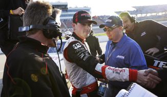 Ryan Blaney, center, celebrates with crew members after qualifying for the NASCAR Nationwide series auto race, Saturday, May 17, 2014, at Iowa Speedway in Newton, Iowa. Blaney won the pole position for Sunday&#39;s race. (AP Photo/Charlie Neibergall)