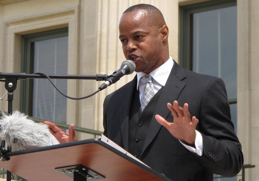 The Rev. Reuben Eckels, co-pastor of the New Day Christian Church in Wichita, Kan, speaks at a rally for education, Saturday, May 17, 2014, at the Statehouse in Topeka, Kan. Participants believe Republican Gov. Sam Brownback has pursued policies that attack public schools. (AP Photo/John Hanna)
