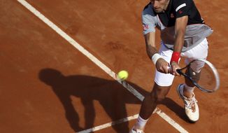 Serbia&#39;s Novak Djokovic returns a backhand during his semifinal match against Canada&#39;s Milos Raonic at the Italian open tennis tournament in Rome, Saturday, May 17, 2014. Djokovic won the match and advanced to the final. (AP Photo/Gregorio Borgia)