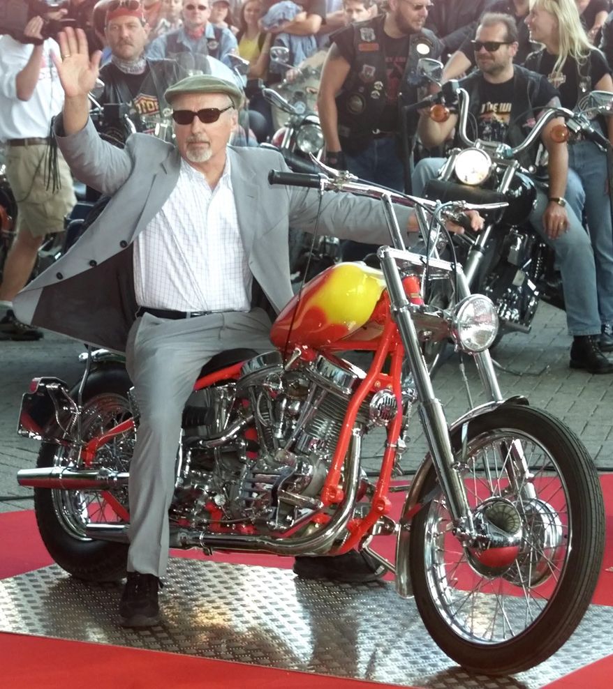 FILE - In this June 22, 2000 photo, actor Dennis Hopper poses on a Harley Davidson motorbike at the ground of the world exposition Expo 2000 in Hanover, Germany. To celebrate the legacy of Dennis Hopper and his iconic counterculture film "Easy Rider," motorcyclists and movie fanatics from as far away as Canada have traveled to northern New Mexico. They're gathering Saturday, May 17, 2014 in the dusty, adobe encircled plaza at Ranchos de Taos to kick off what town officials hope will be an annual event, Dennis Hopper Day. Saturday would have been the late actor's 78th birthday. (AP Photo/ Jan Bauer, File)