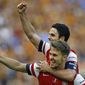 Arsenal&#39;s Aaron Ramsey, front, celebrates with Mikel Arteta after his team won the English FA Cup final soccer match between Arsenal and Hull City at Wembley Stadium in London, Saturday, May 17, 2014. Arsenal won 3-2 after extra-time. (AP Photo/Kirsty Wigglesworth) 