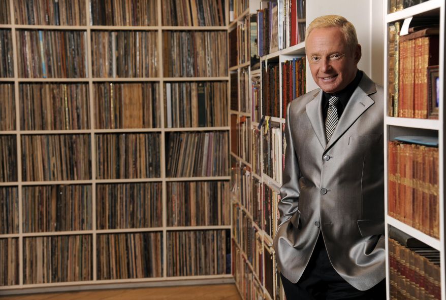 In this Tuesday, April 29, 2014 photo, Elliot Mintz poses for a portrait in his library at his home in Beverly Hills, Calif. Determined to retire after five decades in Hollywood, the 69-year-old is releasing what he calls a “cyberography”: A free website filled with more than 150 hours of his radio and TV interviews comprising hundreds of celebrities and subjects. ElliotMintz.com goes live Sunday, May 18, 2014. (Photo by Chris Pizzello/Invision/AP)