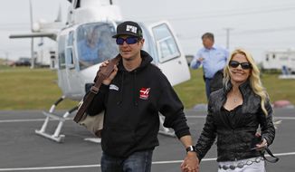 Kurt Busch walk with his girlfriend, Patricia Driscoll, after arriving for the NASCAR Sprint All-Star auto race at Charlotte Motor Speedway in Concord, N.C., Saturday, May 17, 2014. Busch qualified earlier Saturday for the Indianapolis 500. (AP Photo/Terry Renna)