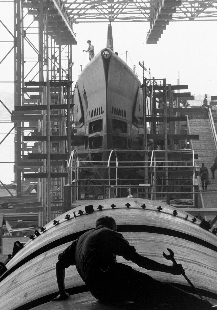 This August 1943 photo provided by the National Archives, General Records of the U.S. Navy, shows a submarine builder at Electric Boat Company in Groton, Conn. The photo is part of "The Way We Worked", part of the Smithsonian's Museum on Main Street program — and opens Saturday, May 17, 2014 in Angola and 270 miles away in Tunica, Mississippi. Identical exhibits also are being shown in Rhode Island, Michigan and California. (AP Photo/Fenno Jacobs, National Archives, General Records of the U.S. Navy)