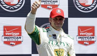 Ed Carpenter celebrates after winning the pole during qualifications for the Indianapolis 500 IndyCar auto race at the Indianapolis Motor Speedway in Indianapolis, Sunday, May 18, 2014. (AP Photo/Michael Conroy)
