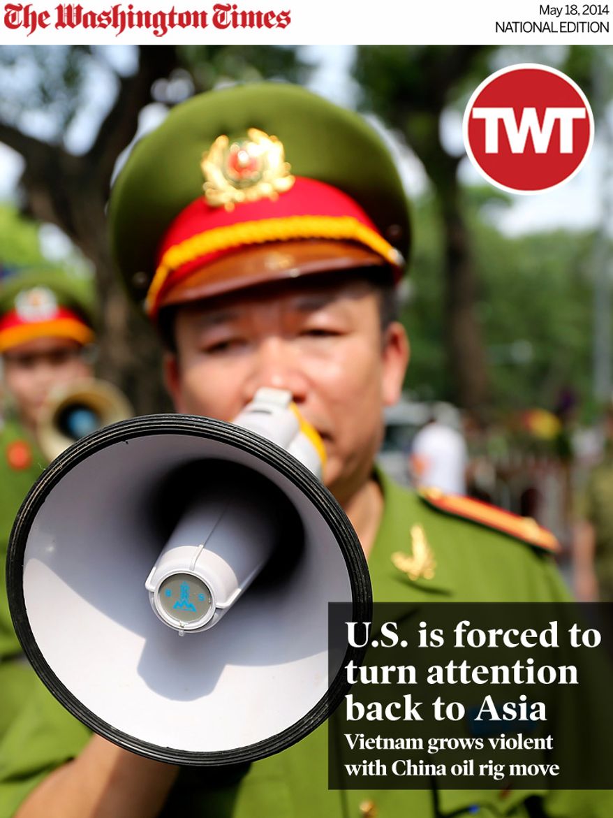 National Edition News cover for May 18, 2014 - U.S. is forced to turn attention back to Asia: A Vietnamese police officer uses a speaker to order pedestrians including journalists to leave a closed area near the Chinese Embassy in Hanoi, Vietnam on Sunday, May 18, 2014. Vietnamese authorities forcibly broke up small protests against China in two cities on Sunday, after deadly anti-China rampages over a simmering territorial dispute risked damaging the economy and spooked a state used to keeping a tight grip on its people. In southern Ho Chi Minh City, police dragged away several demonstrators from a park in the city center. In Hanoi, authorities closed off streets and a park close to the Chinese Embassy and pushed journalists and protesters away. (AP Photo/Na Son Nguyen)
