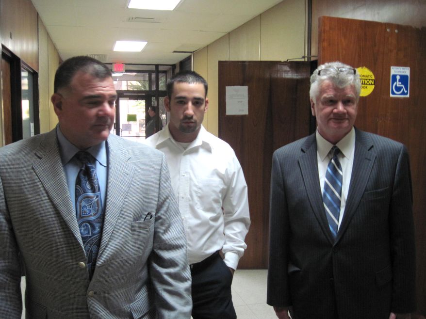 FILE - In this Oct. 22, 2010, file photo, former Winnfield Police Officer Scott Nugent, center, walks with his attorneys Phillip Terrell, left and George Higgins in the Winn Parish Courthouse in Winnfield, La. Nugent was acquitted by a jury in 2010 of manslaughter in the Taser death of Baron "Scooter" Pikes. The Supreme Court could take its first look at police use of Taser stun guns in a case involving the death of Pikes who was shocked by police eight times after he had been placed in handcuffs. The justices could say as early as Monday, May 19, 2014, whether they will add the case of Pikes to their fall calendar. The court is being asked to review a federal appeals court ruling that dismissed a civil rights lawsuit filed on behalf of Pikes’ young son against the former police officer. (AP Photo/The Daily Town Talk, Billy Gunn, File) NO SALES