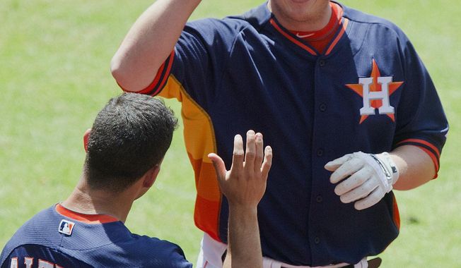 Houston Astros&#x27; Matt Dominguez celebrates with teammate Jose Altuve (27) after hitting his second home run of the baseball game against the Chicago White Sox in the fifth inning, Sunday, May 18, 2014, in Houston. (AP Photo/The Courier, Jason Fochtman)