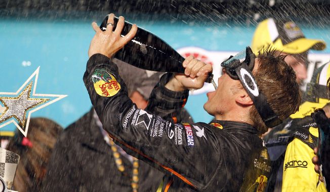 Jamie McMurray celebrates in Victory Lane after winning the NASCAR Sprint All-Star auto race at Charlotte Motor Speedway in Concord, N.C., Saturday, May 17, 2014. (AP Photo/Terry Renna)