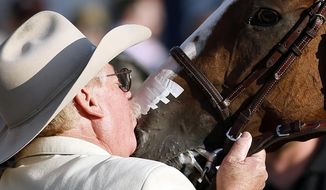 ** FILE ** In this Saturday, May 17, 2014, file photo, co-owner Steven Coburn kisses California Chrome after winning the 139th Preakness Stakes horse race at Pimlico Race Course in Baltimore. (AP Photo/Matt Slocum, File)